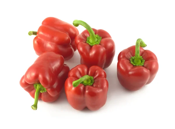 Five red bell peppers isolated close up — Stock Photo, Image