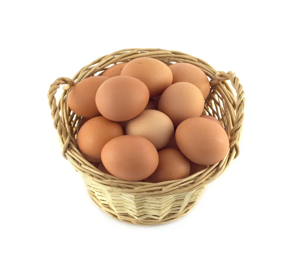 Chicken eggs in wicker basket isolated on white closeup — Stock Photo, Image