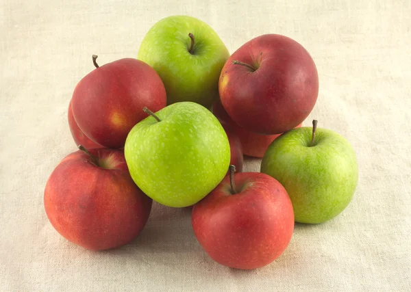 Ripe red and green apples on beige cloth closeup — Stock Photo, Image