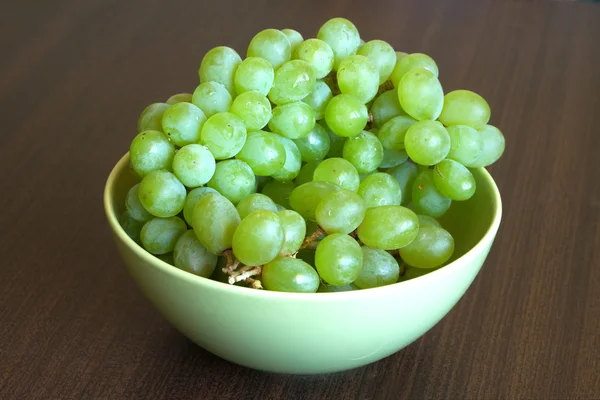 Uva no ramo em tigela verde fechar — Fotografia de Stock