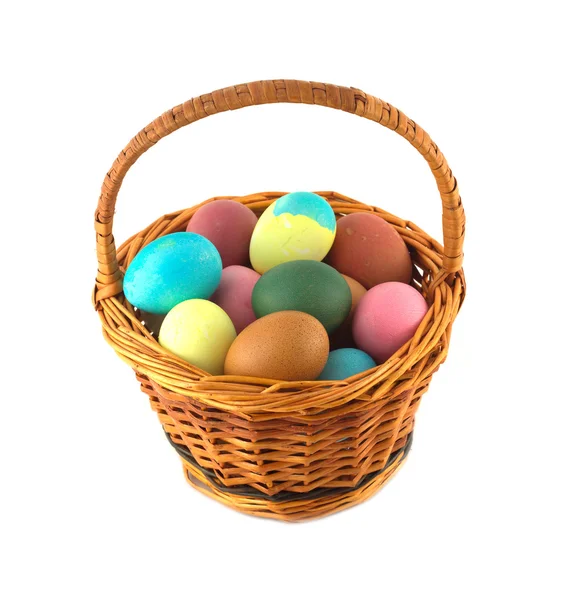 Color Easter eggs in brown basket isolated — Stock Photo, Image