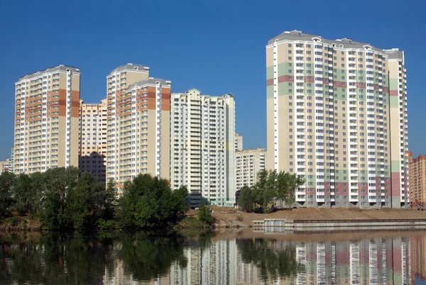 New buildings over river and clear blue sky in summer day Stock Picture