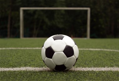 witte en zwarte bal voor het afspelen van voetbal tegen poort close-up