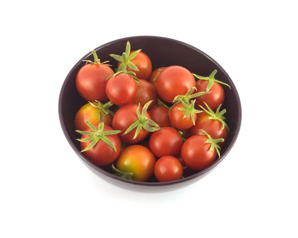 Many ripe tomatoes in purple bowl closeup isolated — Stock Photo, Image