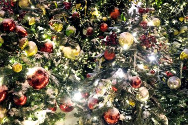 Christmas trees with many colorful balls as background front view close up