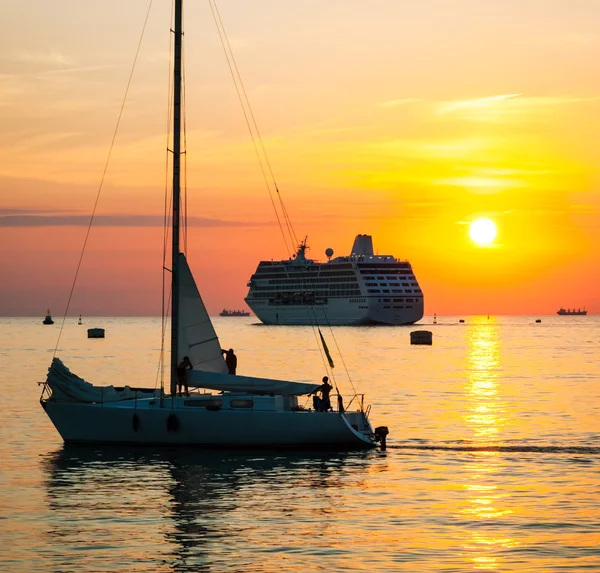 Sunset with yacht and cruise ship
