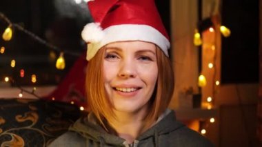 Yeni yıl şapkalı bir kadın Noel ve yeni yıl tatillerini kameraya yansıtmasını diliyor..