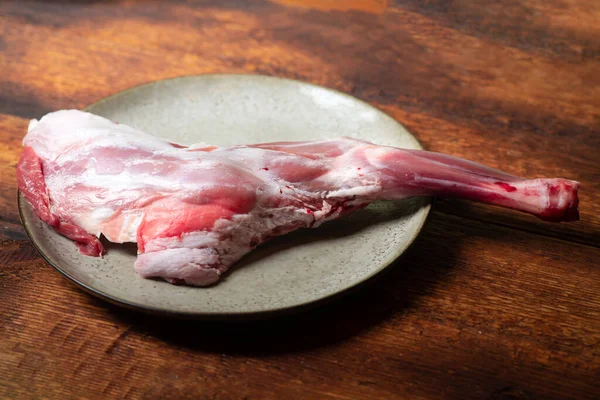 Gamba Agnello Grezzo Piatto Uno Sfondo Legno — Foto Stock