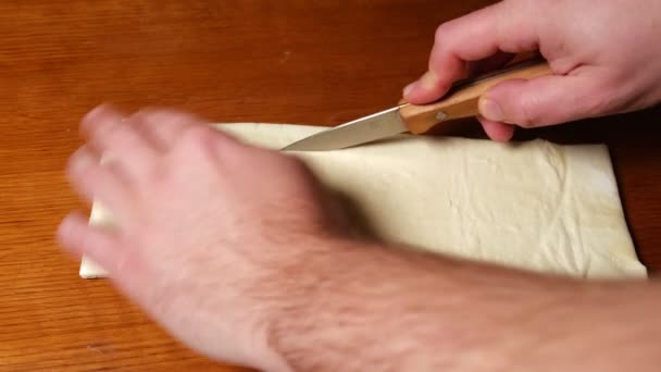 Man Cuts Raw Dough Knife Wooden Background Homemade Buns — стоковое видео