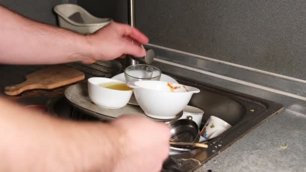 Unrecognizable Man Puts Dirty Dishes Kitchen Sink — Stockvideo
