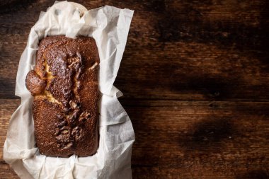 Pişmiş muzlu ekmek. Koyu ahşap arka plan. Cevizli ekmek. Metnin için yer.