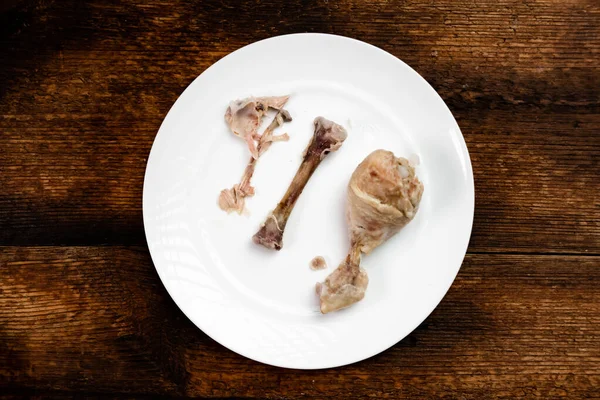 Two Boiled Half Eaten Chicken Legs White Plate Dark Wooden — Stockfoto