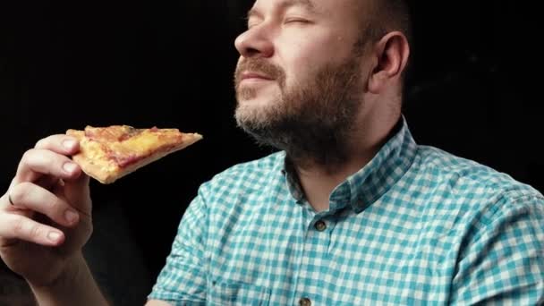 Middle Aged Man Eats Pizza Unshaven Man Shirt Dark Background — Stock Video