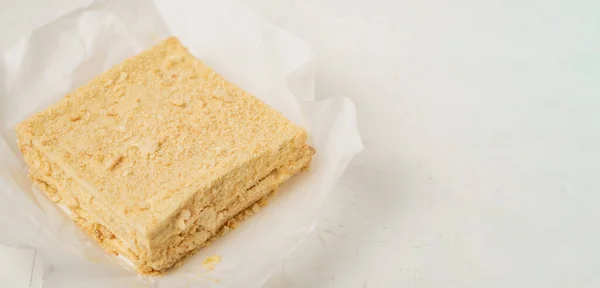 A whole napoleon cake. Vegetarian homemade cake on a white background.