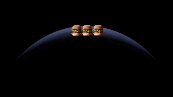 世界汉堡包日的概念 抽象的星球点亮了 汉堡出现了 — 图库视频影像