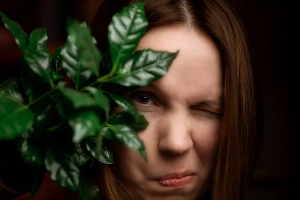 Woman Peeks Out Leaves Funny Facial Expression Surprise Looks Camera — Stock Photo, Image