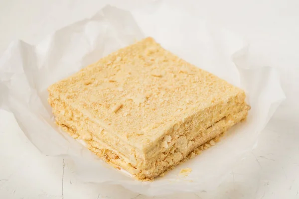 A whole napoleon cake. Vegetarian homemade cake on a white background.