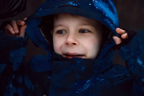 The boy pulled the hoodie in his jacket over his head.