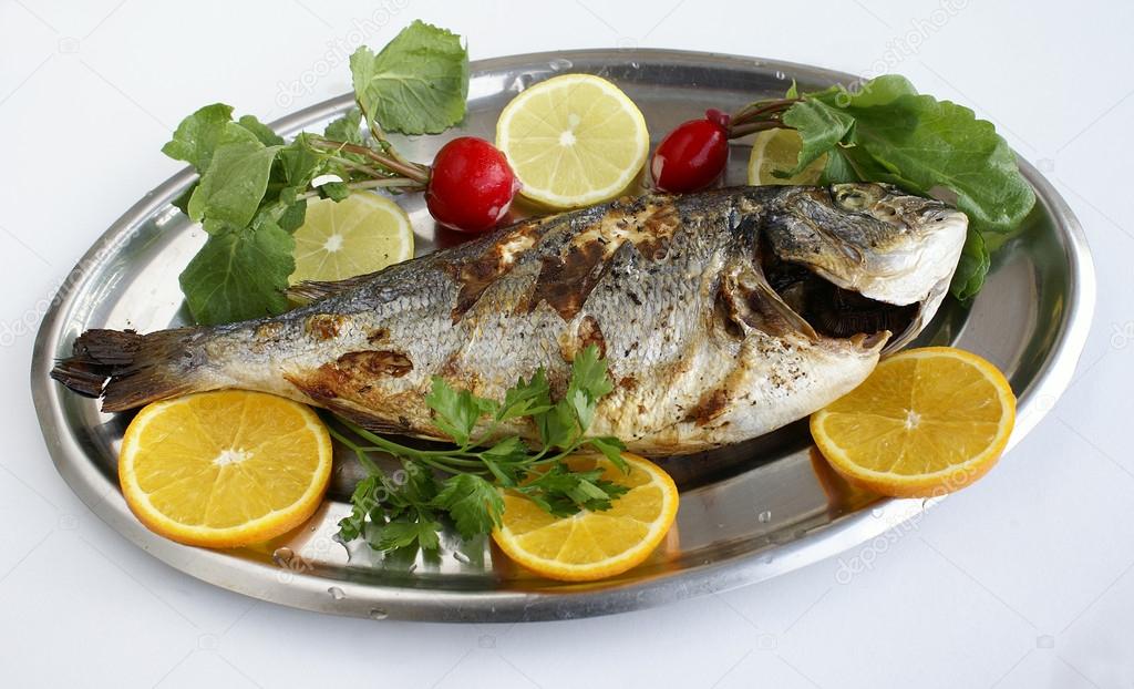 how to cook new year fish grill cooked fish with lemon slices and parsley stock how to cook new year fish grill cooked fish with lemon slices and parsley stock