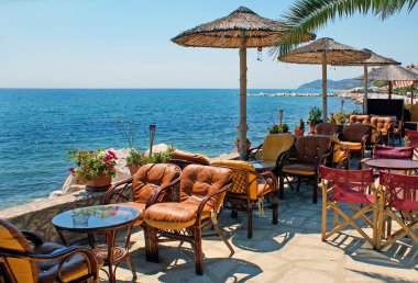 Beautiful cafeteria at the beach, on Santorini island, Greece clipart