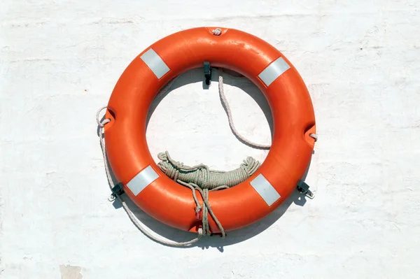 Red Life Buoy hanging on the wall — Stock Photo, Image