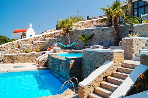 Piscina com degraus de rocha e pequena capela tradicional, Gree — Fotografia de Stock