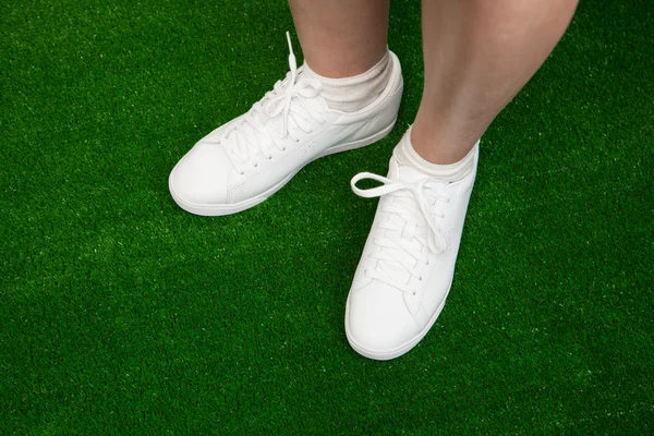 Tennis sneakers on green — Stock Photo, Image