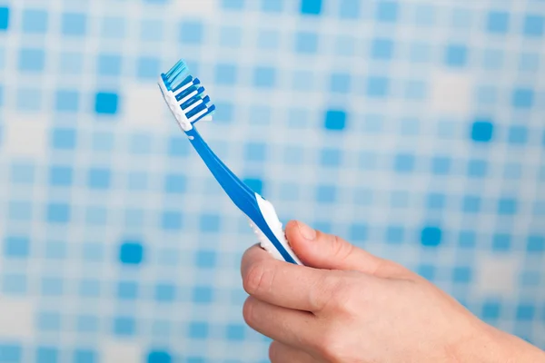 Hand holding toothbrush — Stock Photo, Image