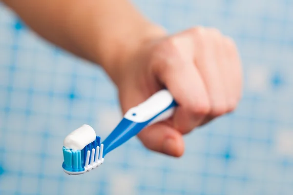 Toothbrush in hand — Stock Photo, Image