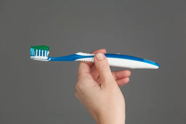 Hand holding toothbrush — Stock Photo, Image