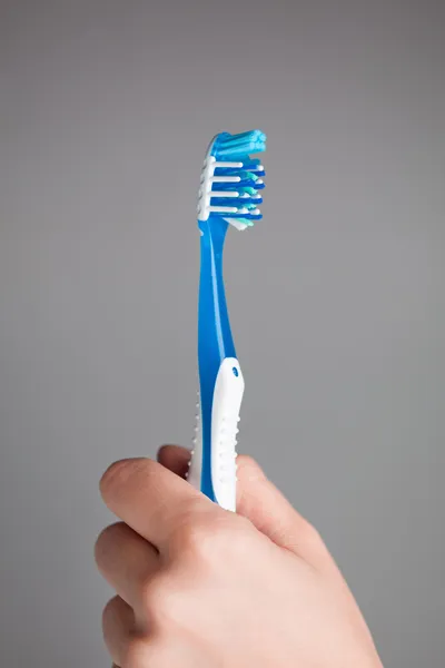 Hand holding toothbrush — Stock Photo, Image