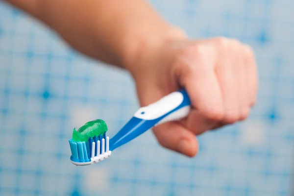 Toothbrush in hand — Stock Photo, Image