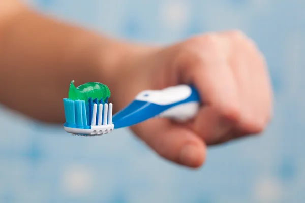 Hand holding toothbrush — Stock Photo, Image