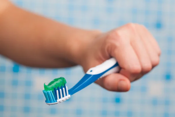 Hand holding toothbrush Stock Image