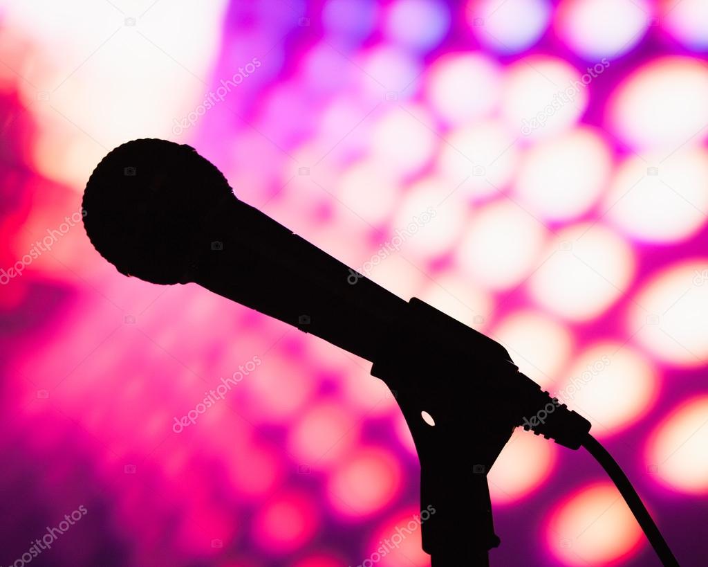 silhouette of microphone against purple disco background