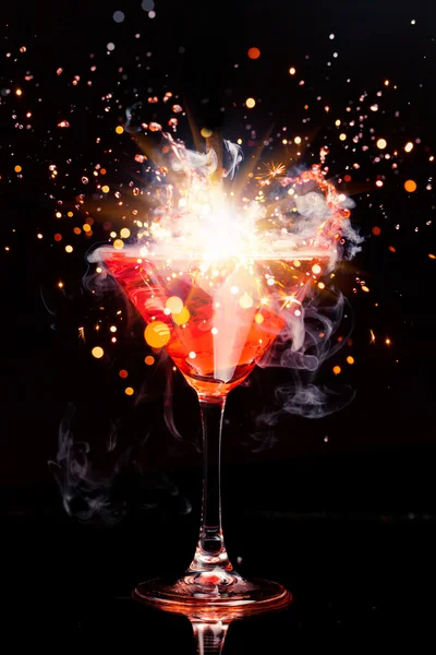 Red cocktail with splash, sparkler and ice vapor — Stock Photo, Image