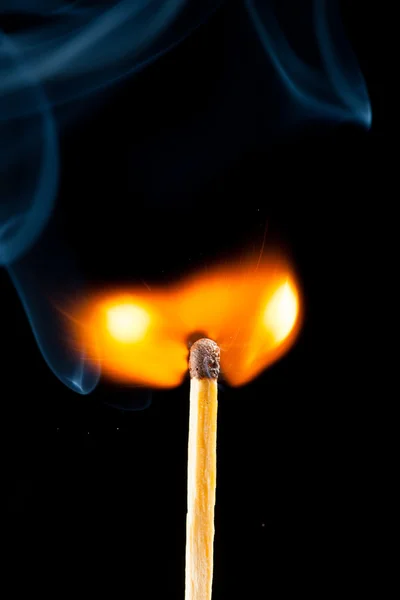 Igniting match with smoke, black background — Stock Photo, Image
