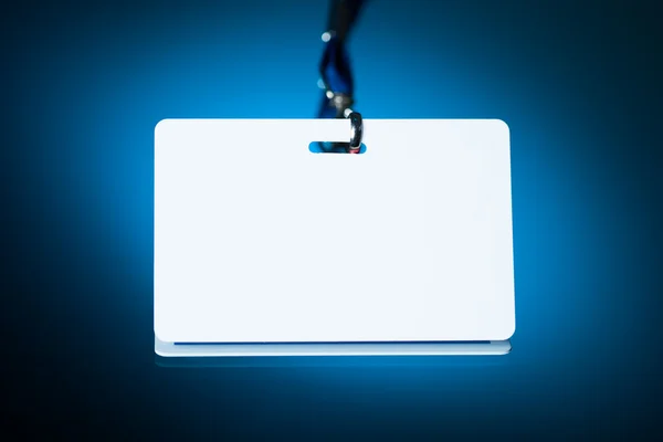 Empty white badge backdrop against blue background — Stock Photo, Image