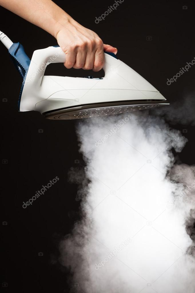 hand holding steam generator iron