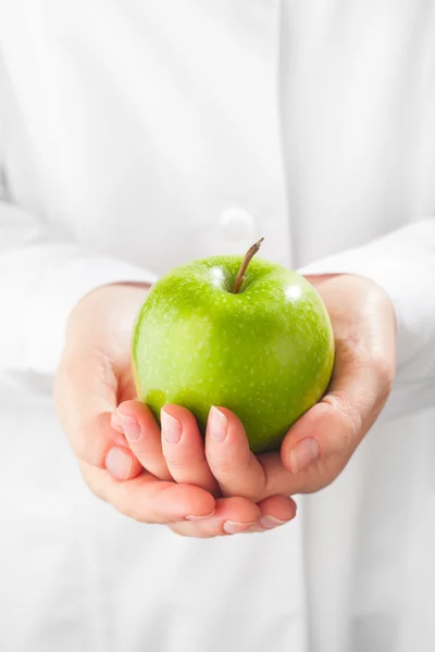 Groene appel in handen, witte achtergrond — Stockfoto
