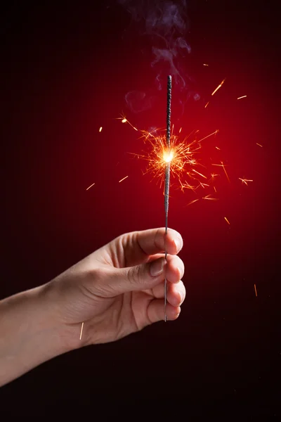 Sparkler in hand — Stock Photo, Image