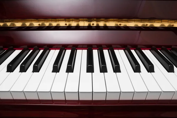 Ebony and ivory keys of red piano — Stock Photo, Image