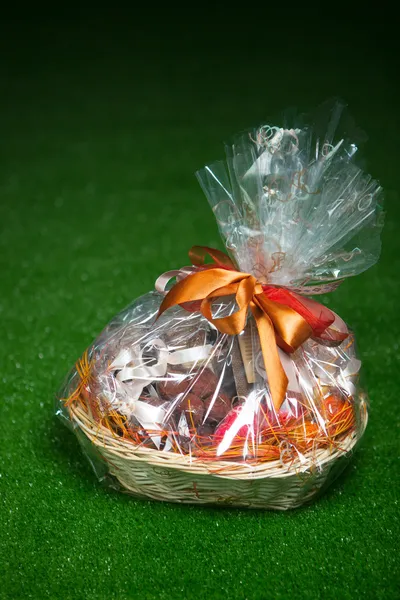 Gift basket against green lawn background — Stock Photo, Image