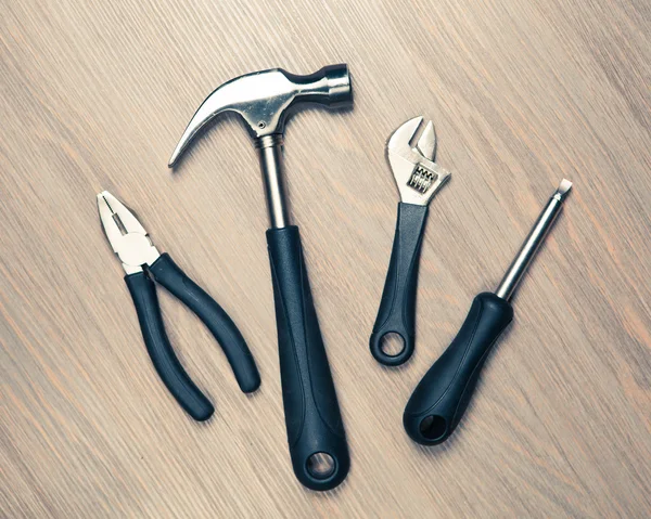 Tools against wooden background — Stock Photo, Image