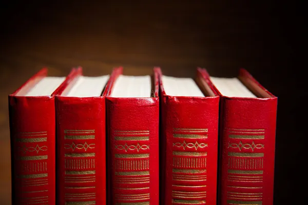 Red books against brown background — Stock Photo, Image