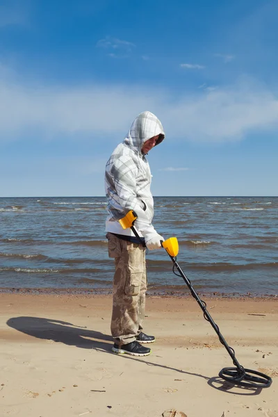 Man searching for a precious metal using a metal detector — Stock Photo, Image