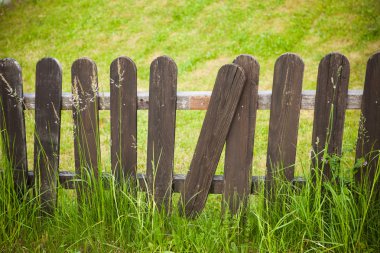 village decorative fence against green lawn background
