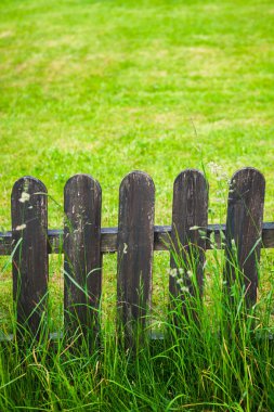 village decorative fence against green lawn background