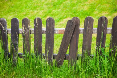 village decorative fence against green lawn background