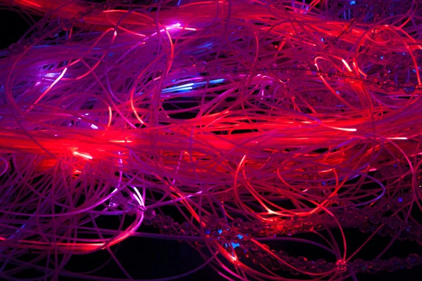 Abstract illuminated red fiber optics cables — Stock Photo, Image
